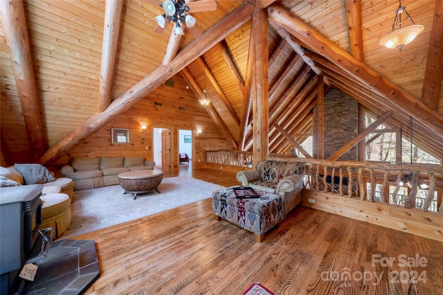 living room with lofted ceiling with beams, wooden ceiling, and hardwood / wood-style flooring