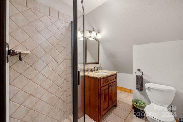 bathroom with lofted ceiling, large vanity, toilet, and tile flooring