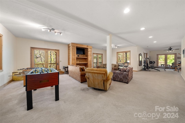 game room with french doors, ceiling fan, rail lighting, a fireplace, and carpet floors