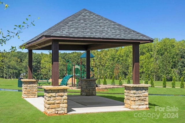 view of property's community featuring a playground, a gazebo, and a yard