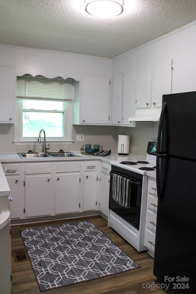 kitchen with dark wood-type flooring, black refrigerator, sink, white electric range oven, and white cabinetry