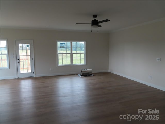 unfurnished room featuring crown molding, ceiling fan, and dark wood-type flooring