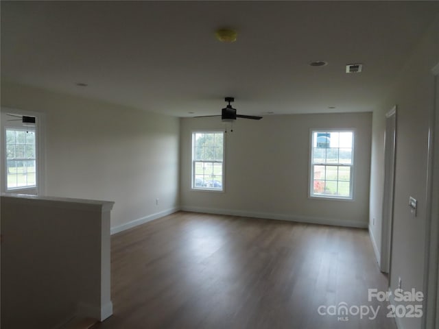 empty room featuring wood-type flooring and ceiling fan