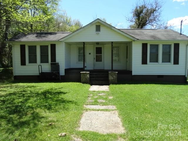 ranch-style home featuring a porch and a front lawn