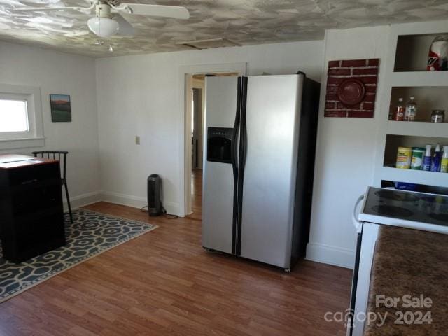 kitchen featuring built in features, white range with electric stovetop, hardwood / wood-style flooring, ceiling fan, and stainless steel fridge with ice dispenser