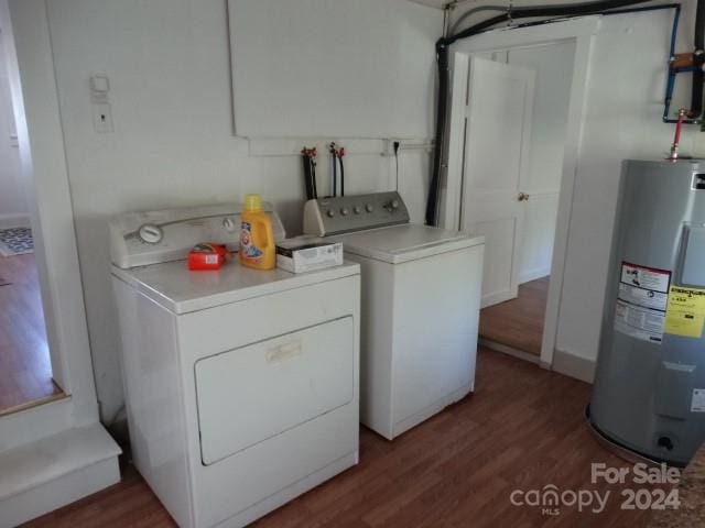 washroom featuring independent washer and dryer, dark hardwood / wood-style floors, and water heater