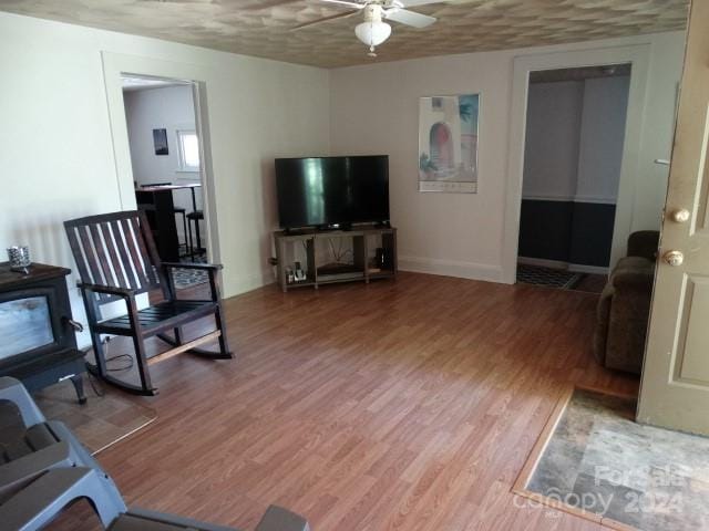 living room with wood-type flooring and ceiling fan