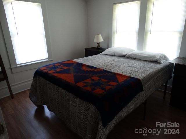 bedroom with wood-type flooring