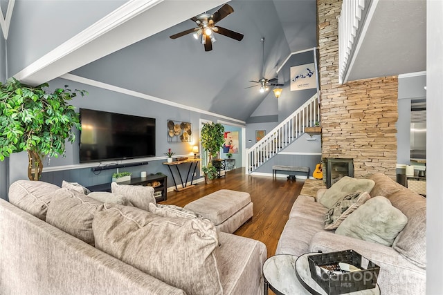 living room featuring ceiling fan, dark hardwood / wood-style flooring, crown molding, and a fireplace