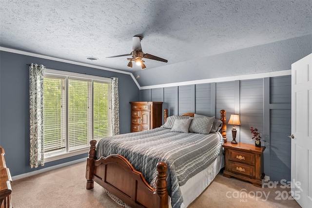 carpeted bedroom featuring ceiling fan, vaulted ceiling, crown molding, and a textured ceiling