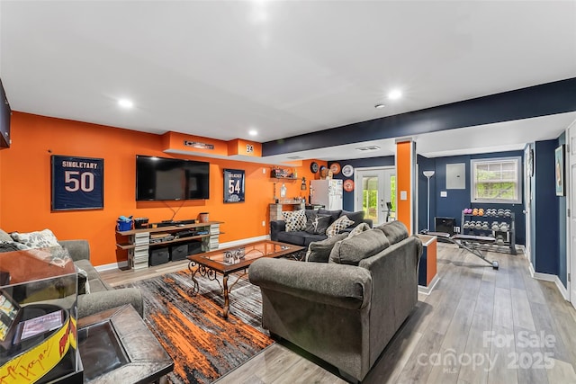 living room featuring french doors and light hardwood / wood-style flooring