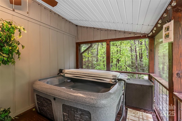 sunroom / solarium with a hot tub, vaulted ceiling, and plenty of natural light