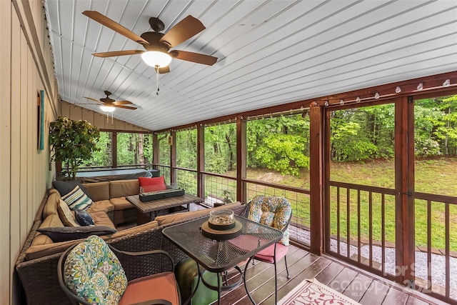 sunroom / solarium with ceiling fan and vaulted ceiling