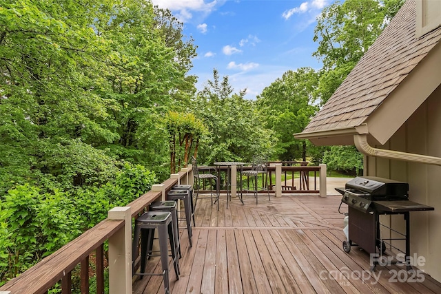 wooden terrace featuring a grill