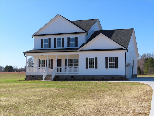 view of front facade with a garage, a front yard, and a porch