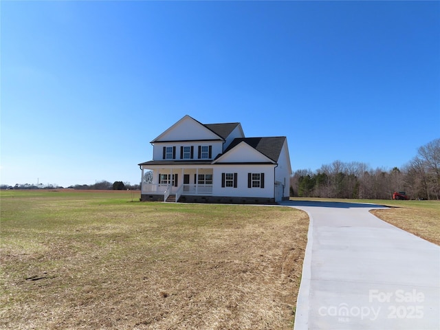 view of front facade with covered porch and a front lawn