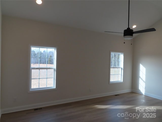 empty room with dark hardwood / wood-style flooring and ceiling fan