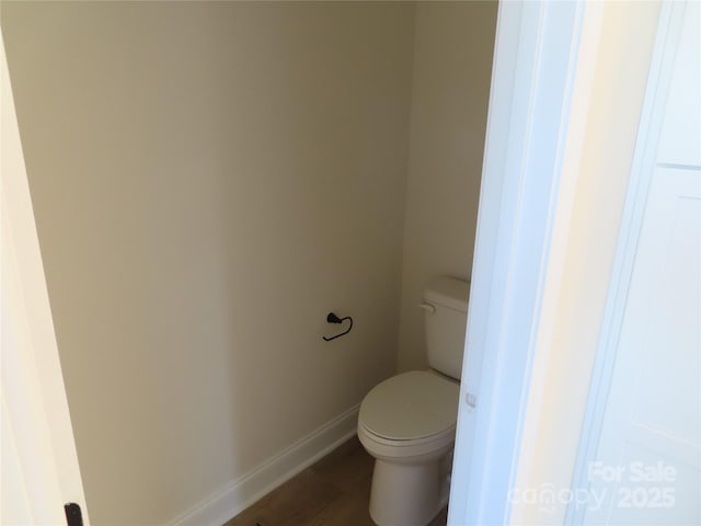 bathroom featuring hardwood / wood-style floors and toilet