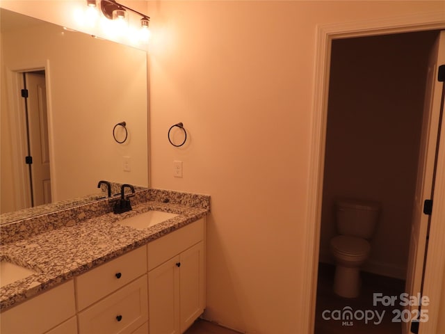 bathroom with vanity and toilet