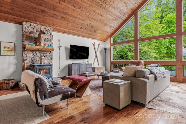 living room with high vaulted ceiling, plenty of natural light, a fireplace, and wood ceiling