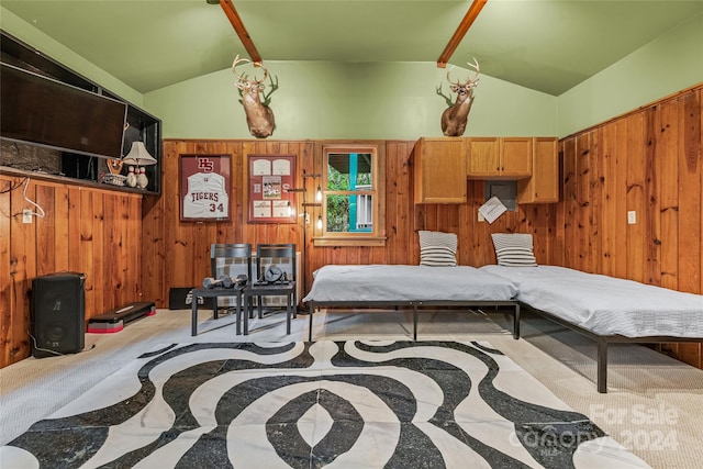 bedroom featuring carpet floors, wood walls, and lofted ceiling