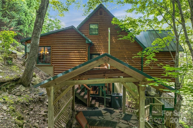 exterior space featuring central AC unit and a deck