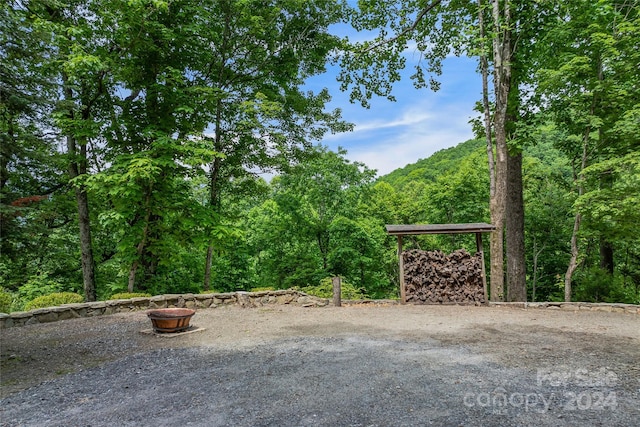 view of gate with an outdoor fire pit