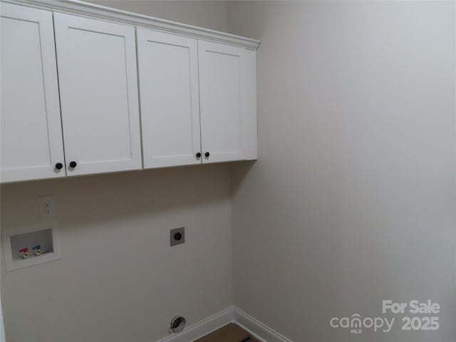 clothes washing area featuring electric dryer hookup, washer hookup, and cabinets