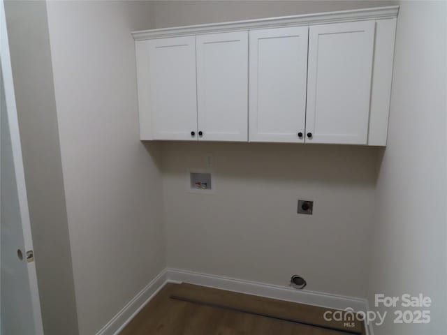 washroom with cabinets, electric dryer hookup, dark wood-type flooring, and washer hookup