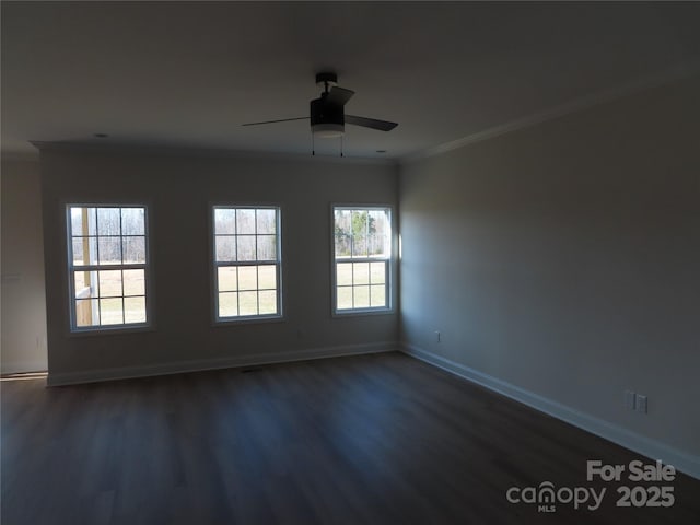 spare room featuring dark hardwood / wood-style flooring, ornamental molding, and ceiling fan