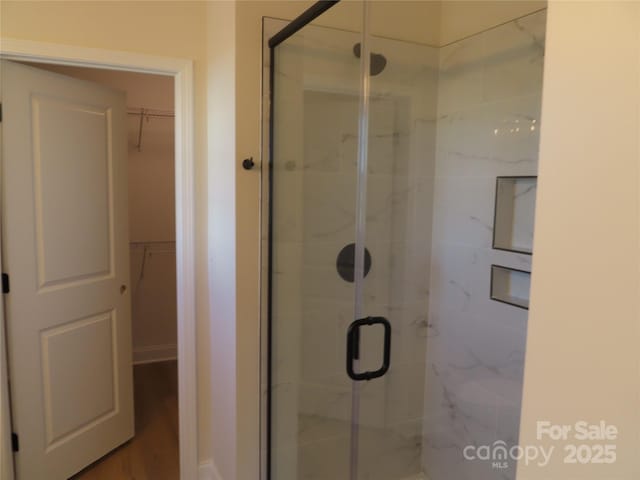 bathroom featuring a shower with door