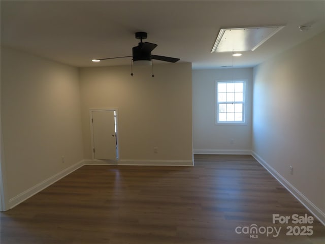 empty room with dark wood-type flooring and ceiling fan