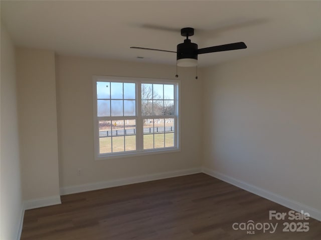 empty room with dark wood-type flooring and ceiling fan