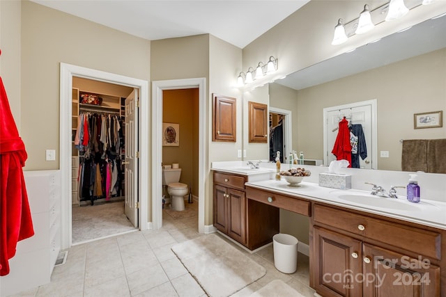 bathroom featuring tile patterned floors, toilet, and vanity