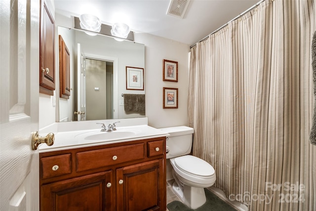 bathroom with vanity and toilet