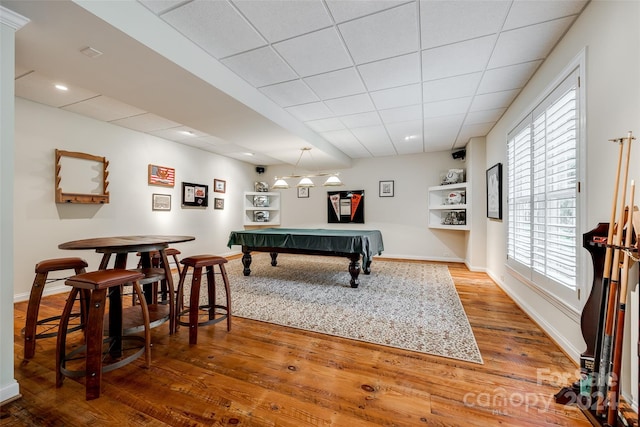 game room with a paneled ceiling, billiards, and hardwood / wood-style flooring