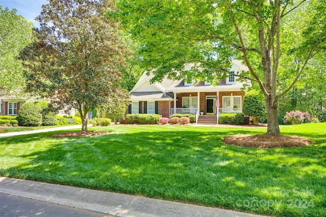 view of front facade with a front yard and a porch