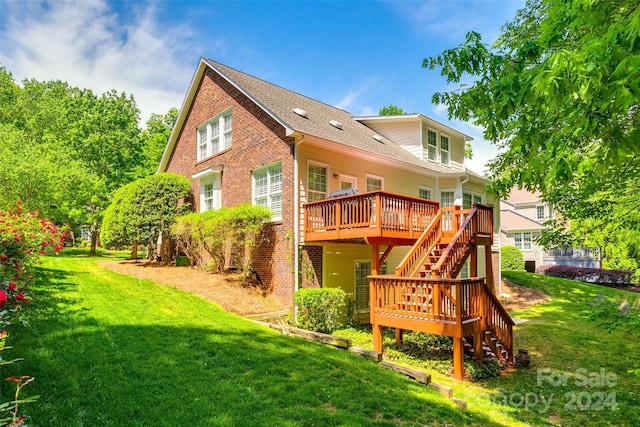 back of property featuring a wooden deck and a yard