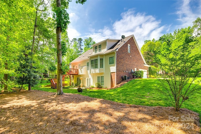 back of house featuring a yard and a wooden deck