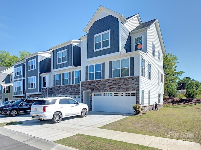 multi unit property featuring a front yard and a garage