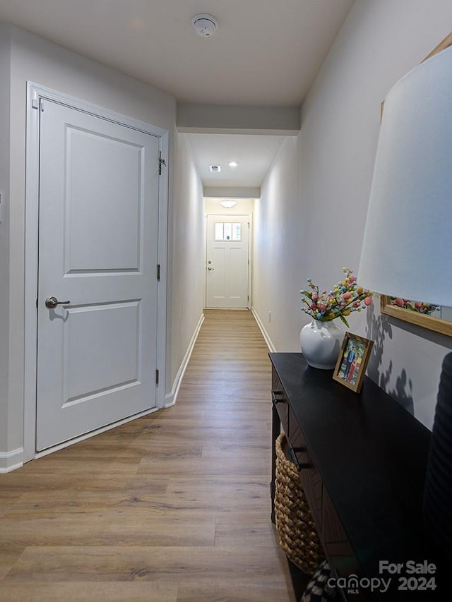 hallway with wood-type flooring