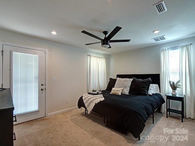 bedroom featuring light carpet and ceiling fan