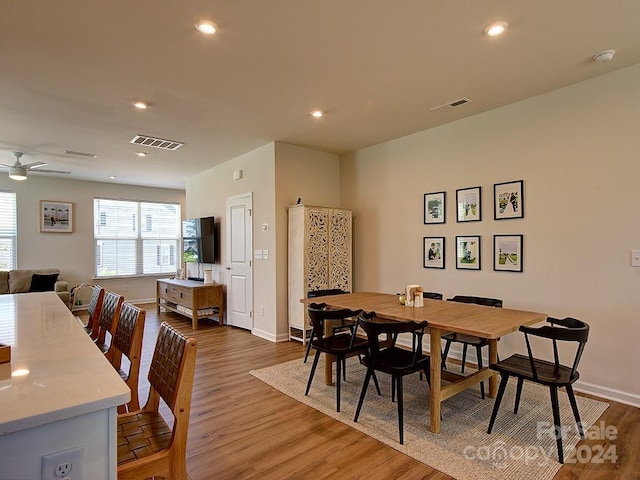 dining space featuring hardwood / wood-style floors and ceiling fan