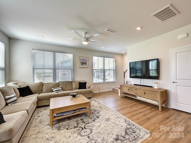 living room with ceiling fan and hardwood / wood-style flooring