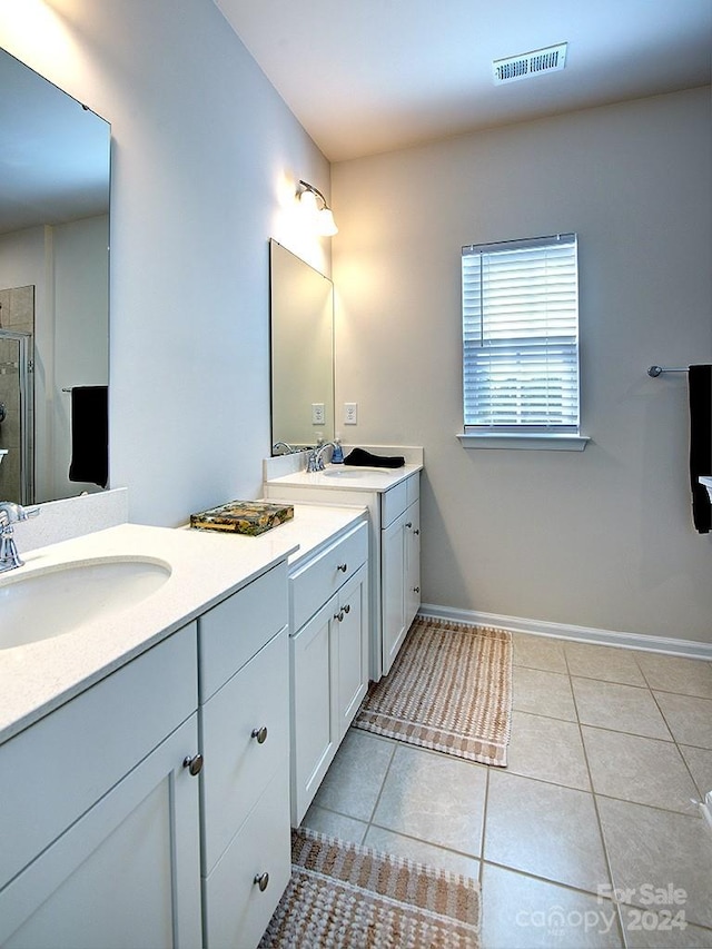 bathroom featuring dual sinks, tile flooring, and large vanity