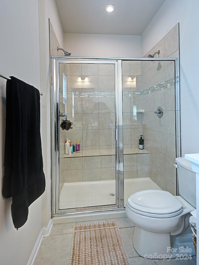 bathroom with an enclosed shower, toilet, and tile flooring