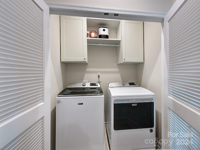 laundry room with cabinets and separate washer and dryer