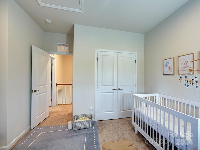 carpeted bedroom with a closet and a crib