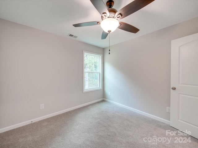 unfurnished room with ceiling fan and light carpet