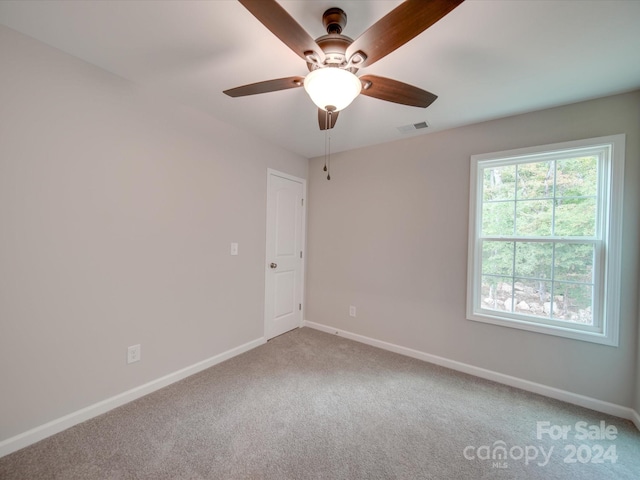 empty room featuring carpet floors and ceiling fan